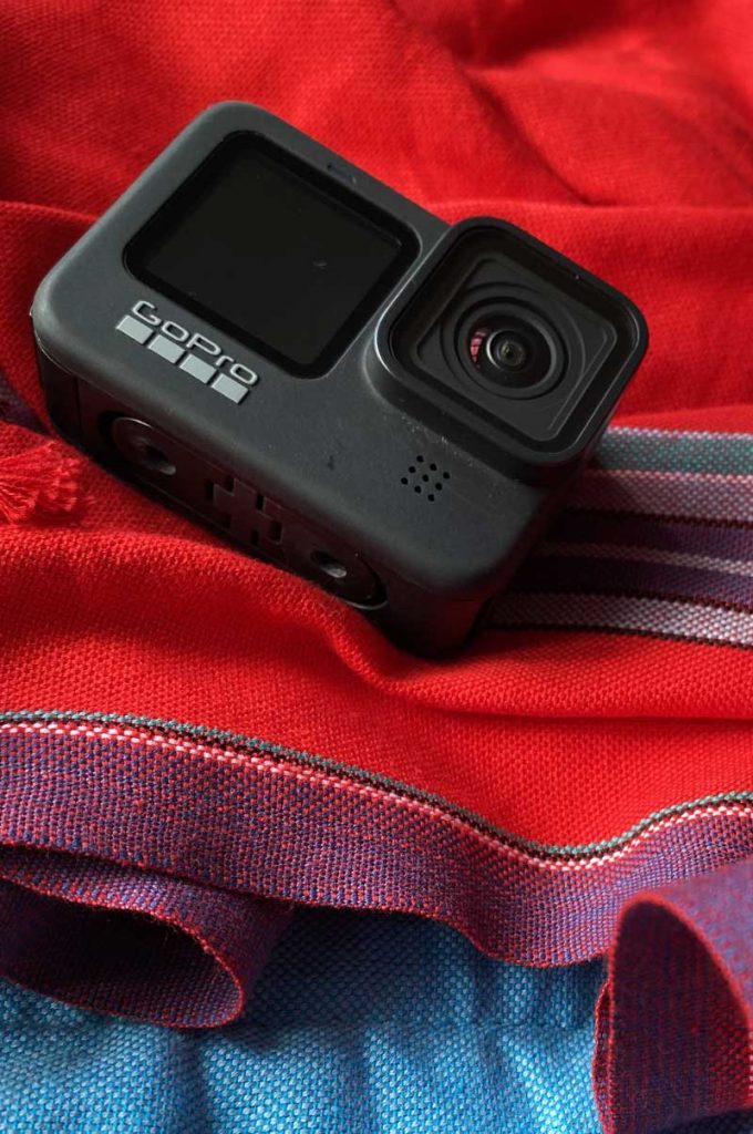 A Close up of a go-pro camera sitting on a red scarf