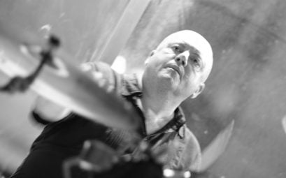 A black and white photo of a man drumming
