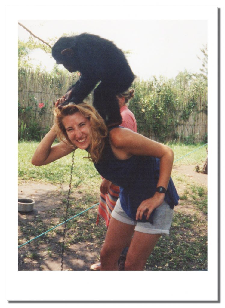 A Young woman with a Chimpanzee on her shoulders