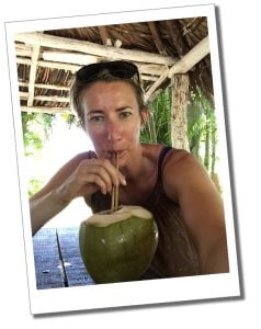 SueWhereWhyWhat drinking a rum cocktail from a Coconut in the Caribbean