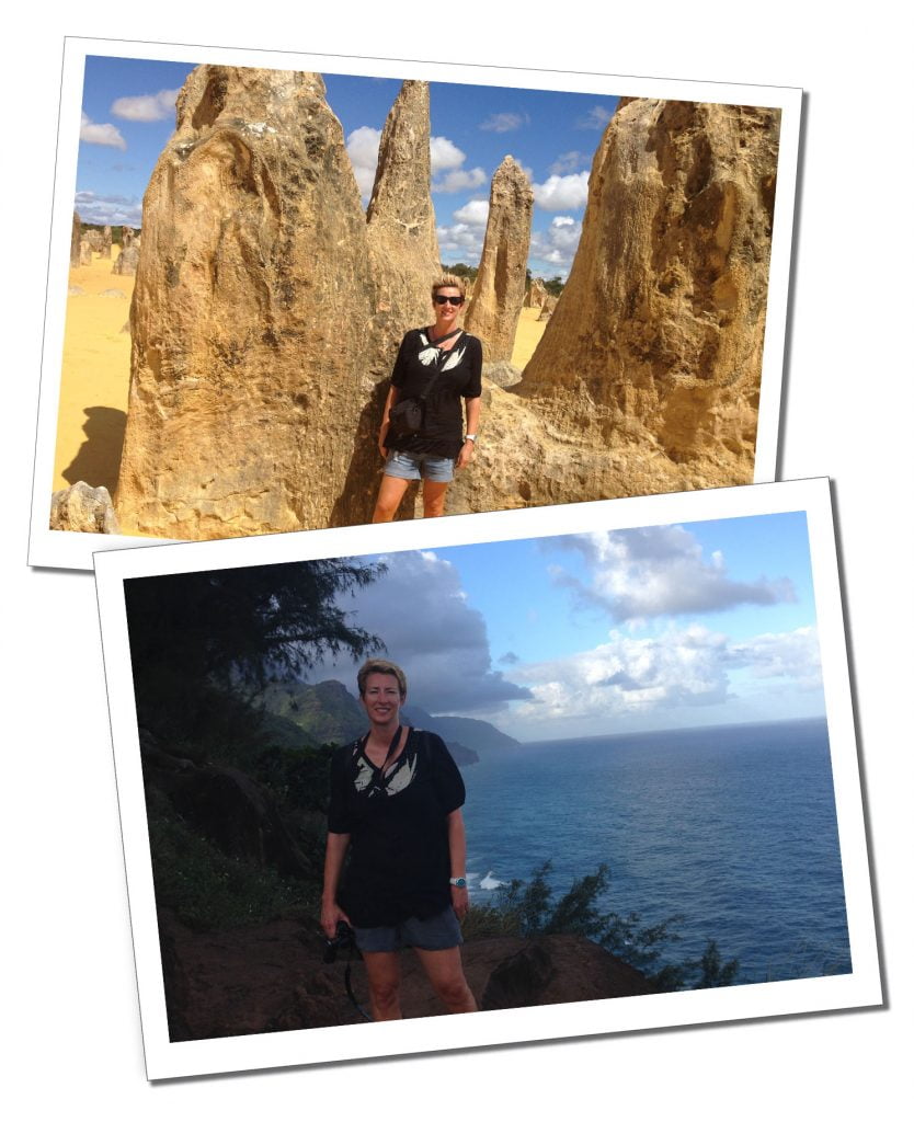 A blonde Woman standing in a dark top beside a dark blue sea and some spiking yellow rocks