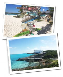 Views of a painted wooden sign pointing in numerous directions on the beach & a lodge on stilts by the shore Great Exuma, Bahamas, Caribbean