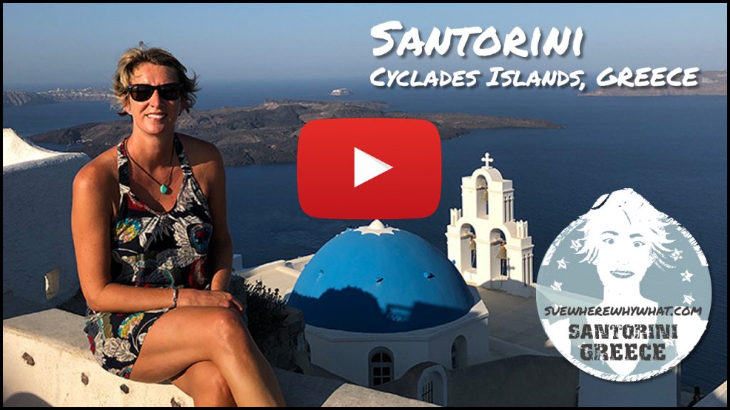 A blonde Woman in a summer dress and sunglasses sitting on a white wall overlooking a blue domed church and the hot serenity of Santorini bay on a clear day of blue sea and blue skies - with a white text overlay and red Youtube button