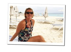 Suewherewhywhat relaxing on the white sand of 7 mile beach in Grand Cayman, Caribbean