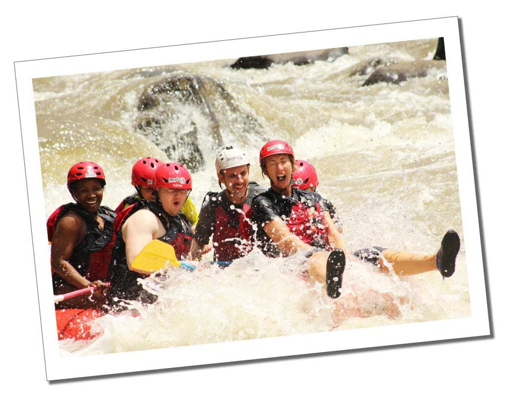 6 People white water rafting in a cascading torrent of foam