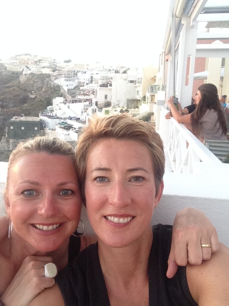 SueWhereWhyWhat on the right and her sister Al pose for a close up 'selfie' on a balcony over looking Santorini, Greece
