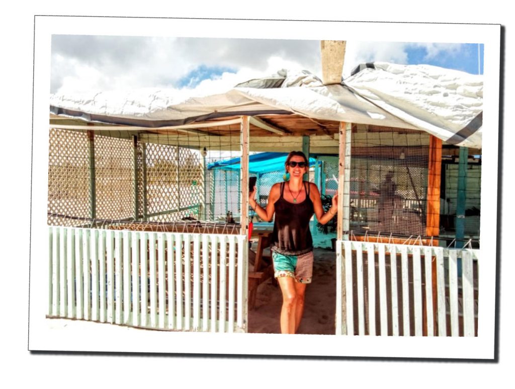 SWWW smiling outside the Lobster Hut on the beach in Barbuda