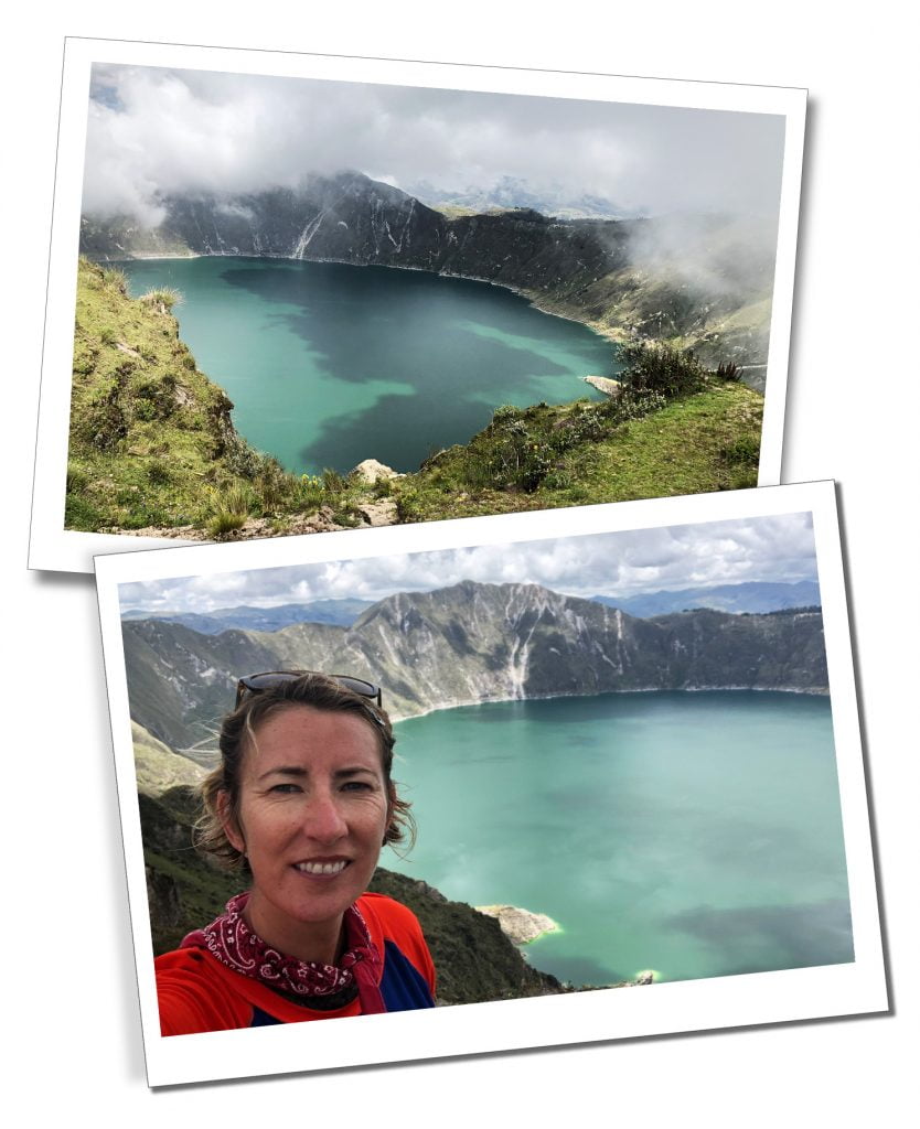 A Woman in a sunglasses and orange top smiling in front of a backdrop of a large green bowl shaped lake