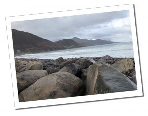 Rocky beach and mountainous backdrop at Rossbeigh Strand on the Ring of Kerry