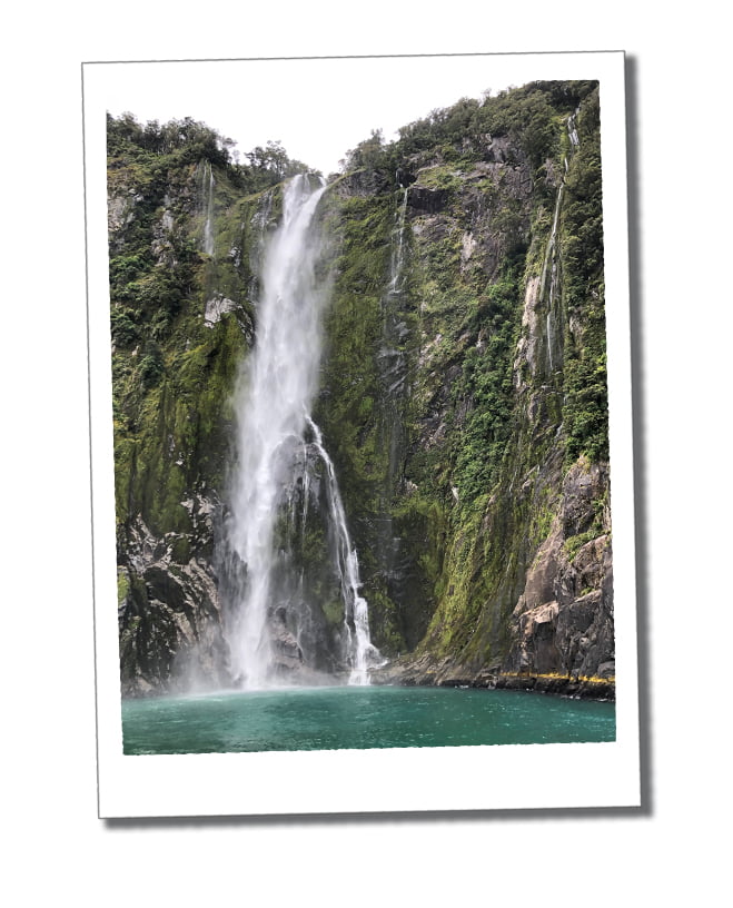 Dramatic cascade of water down a steep great cliff face of Stirling Falls, Milford Sound
