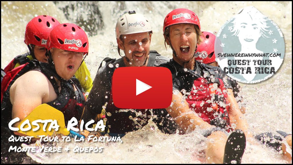 A group of men and women crashing through the wild foam and spray of white water rafting in Costa Rica - Taking the Quest Tour to La Fortuna, Monte Verde & Quepos with G Adventures