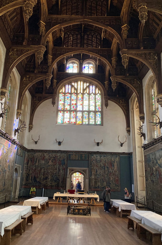 The Medieval Great Hall at Hampton Court with it's oak beams, high ceiling and stained glass window