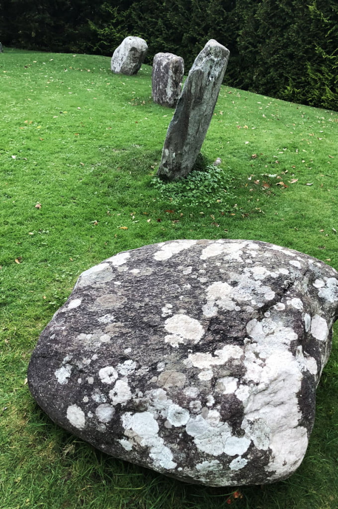 The large stones that make the circle at Kenmare sit in a neatly cut grass field - The Ring of Beara Route. A Road Less Travelled on the Wild Atlantic Way in Cork