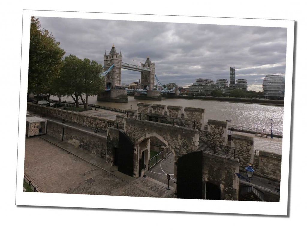Views from the Tower of London battlements over to the thames and tower bridge on a cloudy day