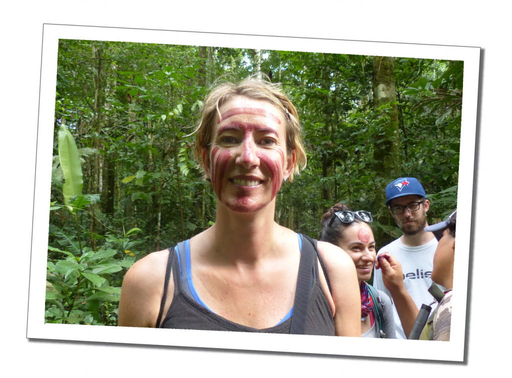 SueWhereWhyWhat, stands smiling facing the camera with her face painted in red stripes by the tour guide. Amazon, Peru What have I achieved on my Life List in 2017?
