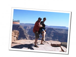 A man and woman standing at the edge of the Grand Canyon USA