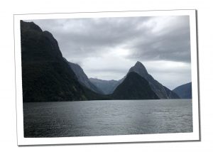 The dark imposing Mitre Peak, Milford Sound looms triangular straight from the shore