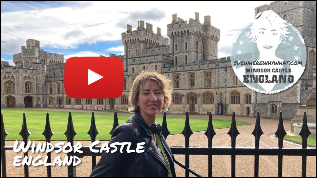 A Smiling blonde woman standing in front of a black railing fence with Windsor Castle behind with a large red youtube button and white text overlay