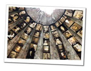 Strips of portraits of people in black and white and sepia hanging from the wall of bunker in Albania