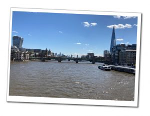 Views from Blackfriars bridge over to the thames to the millennium bridge, the shard and a distant tower bridge on a bright sunny day in London