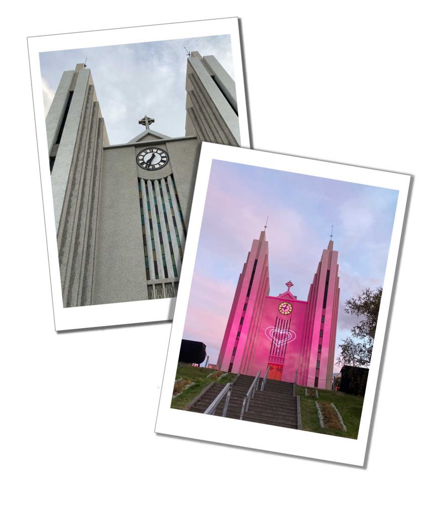 A large imposing angular church with a clock on the front illuminated by a pink glow and white heart
