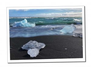 Large ice crystals on a black sand beach