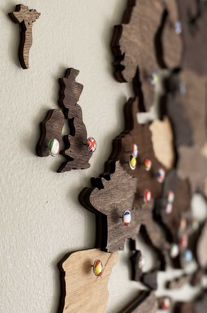 A Wooden Map of Europe attached to a white wall