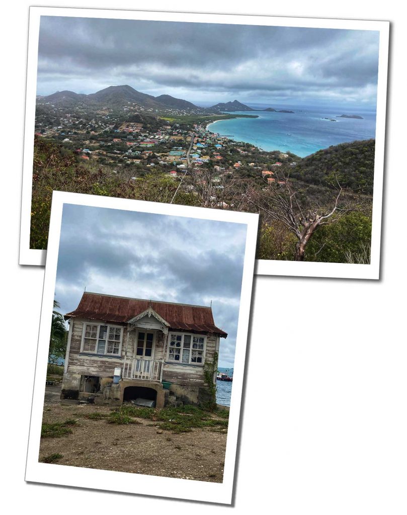 A deserted shack with broken windows and a view of a small settlement by the sea on a cloudy day in the caribbean