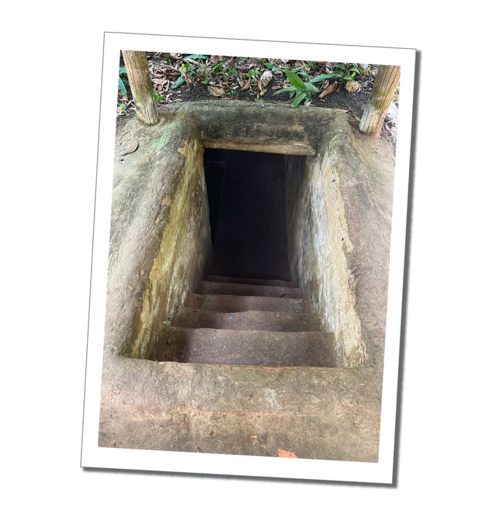 entrance to steps and a dark doorway into the Cu Chi Tunnels network