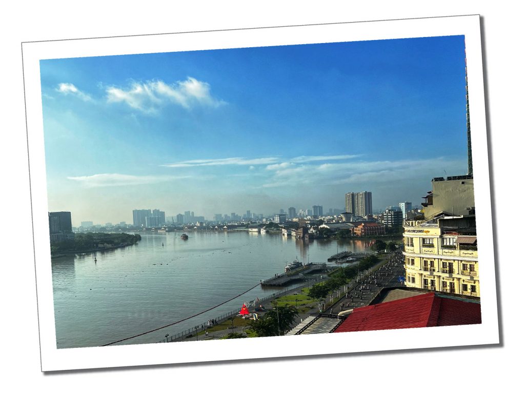A Panoramic view of a large river and distant city scape from the Hotel Saigon in Vietnam
