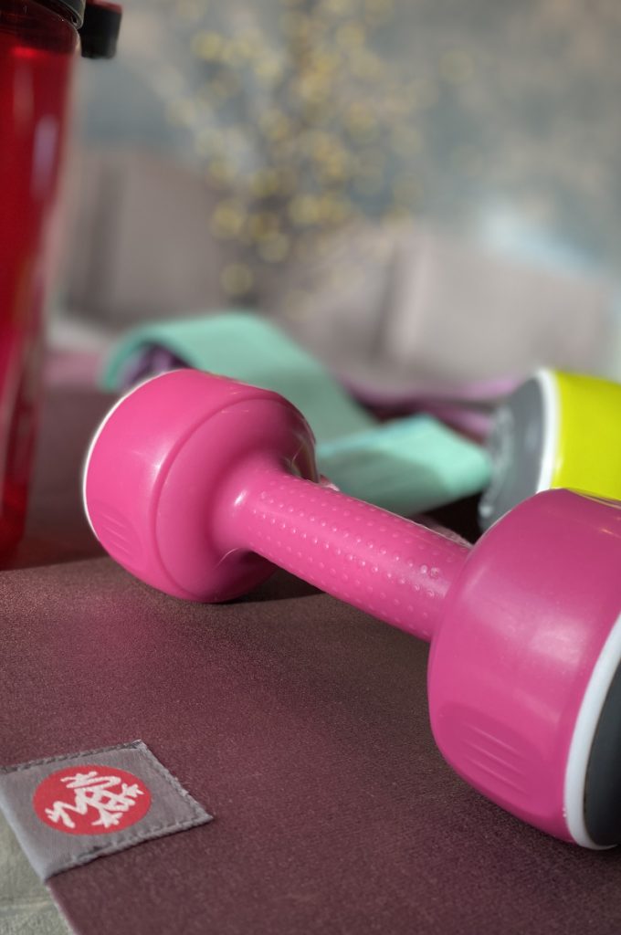 A Pink Dumbell on a yoga mat