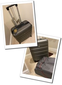 A wheel on suitcase with a passport on top of it