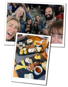 A group of people drinking pints of beer on the street and a picture of beeves and dips arranged on slate place mats on a table