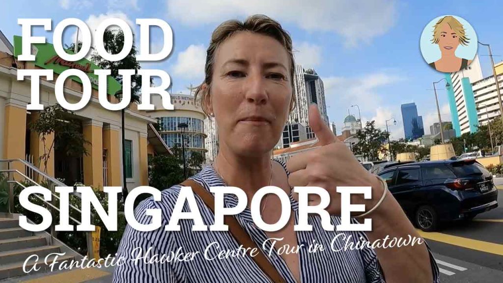 A blonde woman giving thumbs up on the streets of singapore