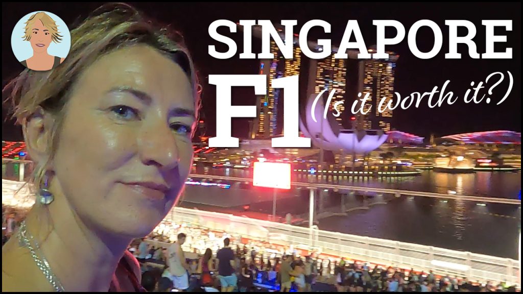 A blonde woman smiling at the camera with an evening grand prix race track behind her