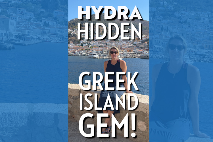 A blonde woman sitting on a wall beside a tranquil seaside setting in the sunshine